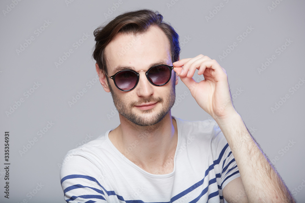 Studio shot of handsome man wearing sunglasses Studio shot of handsome man wearing sunglasses