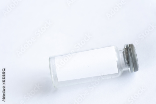 glass test tube with white blank label on an isolated background photo