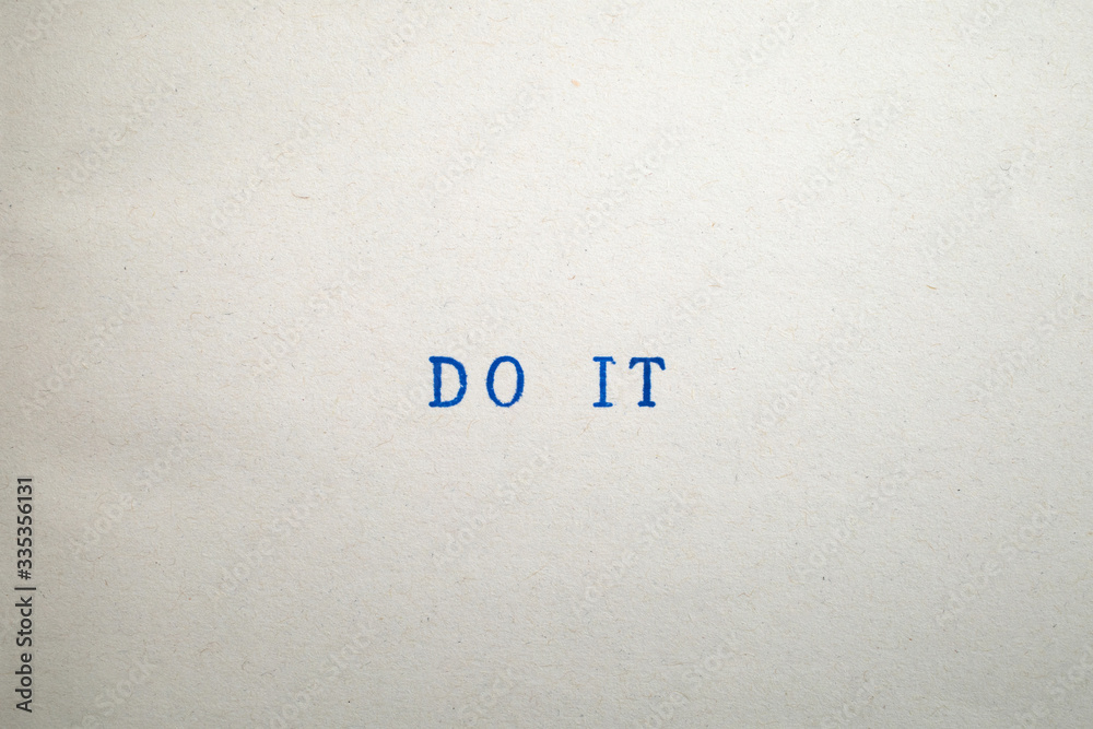 a DO IT word stamped on a piece of paper. a DO IT word stamped on a piece of paper.