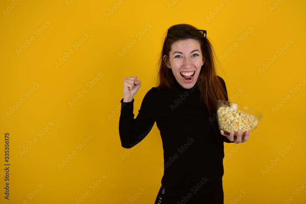 joyful cheerful woman with emotions holds a plate with popcorn joyful cheerful woman with emotions holds a plate with popcorn