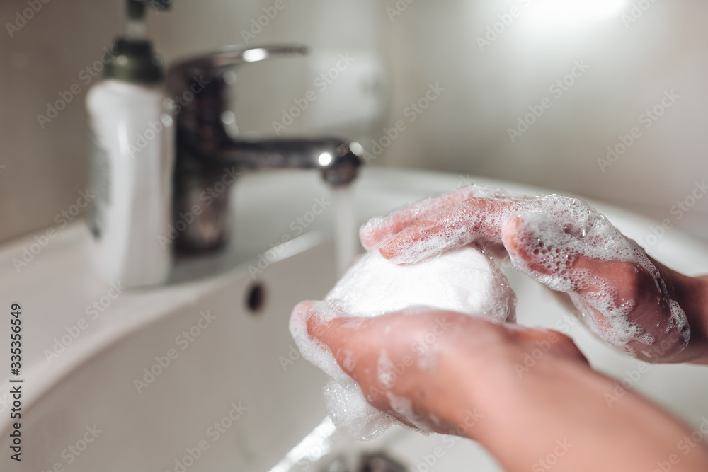 Fototapeta premium Man washing hands to protect against the coronavirus