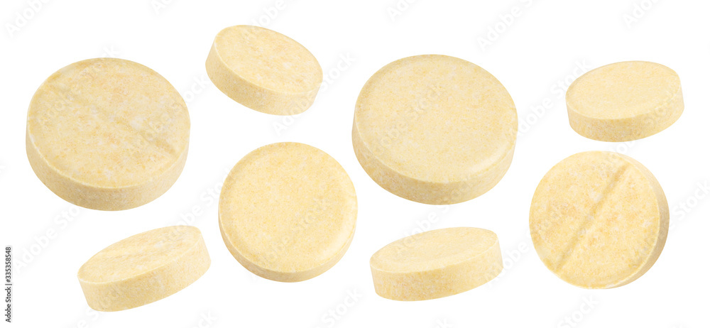 yellow textured pills isolated on white