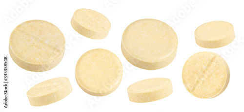 yellow textured pills isolated on white