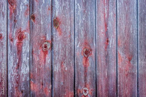 Purple and red texture of an old wooden fence with abstract pattern, table board background