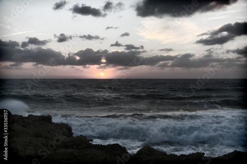 Stormy sunset on the Mediterranean Sea. Evening. Rocky coast. Sea Caves, Peyia, Cyprus © IvSky