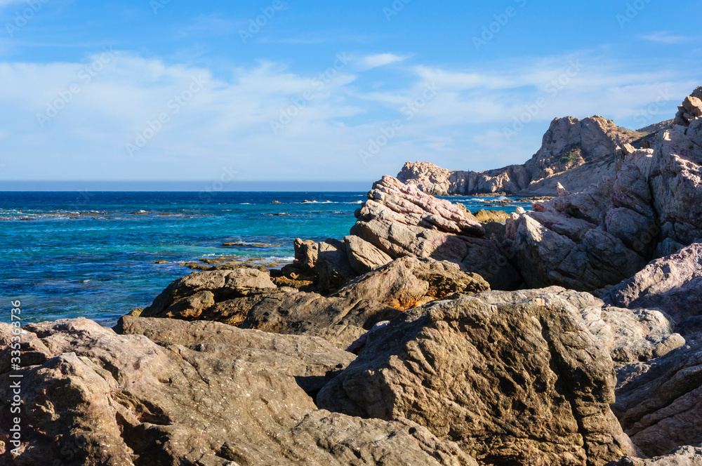 Set of rocks on the shore of the blue sea without people