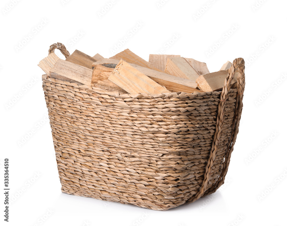 Obraz premium Wicker basket with cut firewood isolated on white