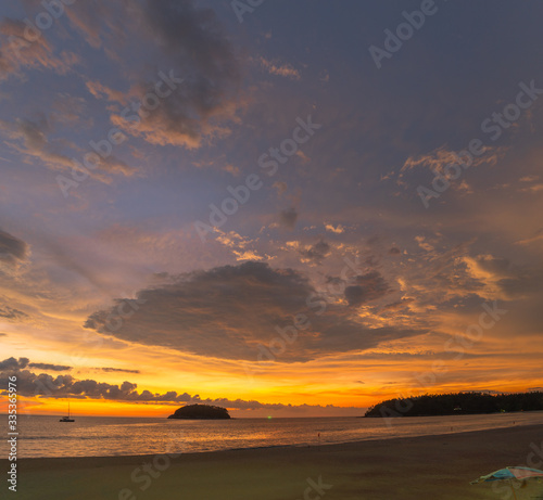 .beautiful cloud in golden sky at sunset in Kata beach Phuket Thailand.