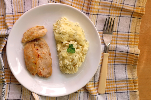 Plate with chicken breasts and mashed potatoes. Top view.