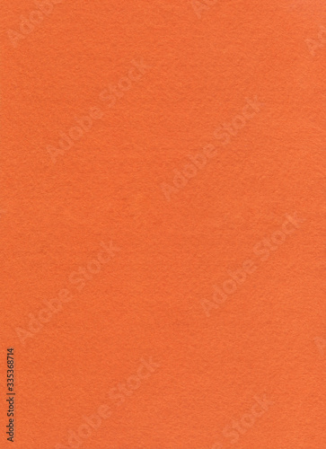 Orange Fleecy Material Texture. Bright detailed fibers fluffy surface background. Positive abstract texture of fleecy knitted fabric. Close-up texture of velvet paper, red suede, nubuck textile