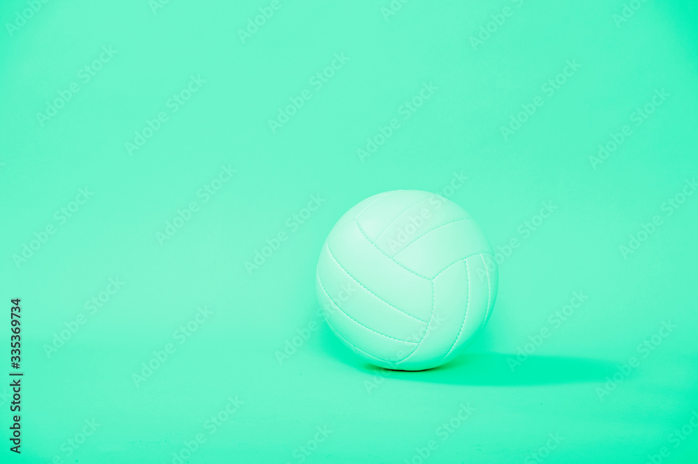 Volleyball ball isolated on green background.