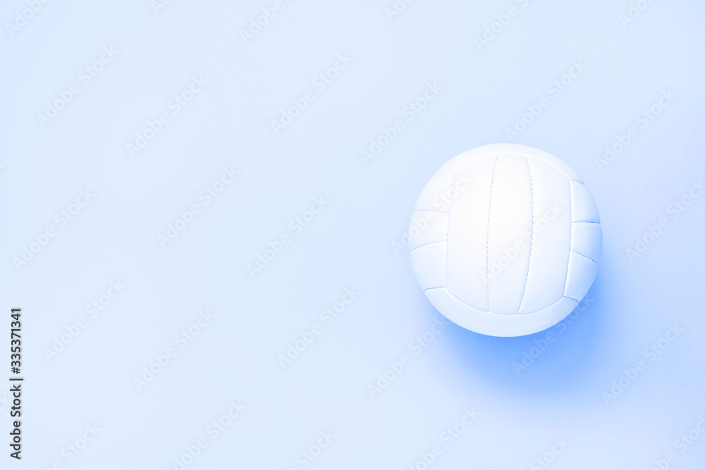White volleyball leather ball on blue background. Top view.