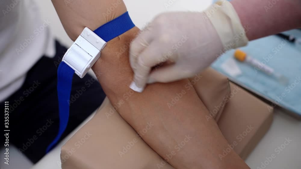Close-up of the process of taking blood from the vein from man for biochemical blood testing. Preparation for blood test with by phlebotomist technician doctor in medical clinic. Close-up of the process of taking blood from the vein from man for biochemical blood testing. Preparation for blood test with by phlebotomist technician doctor in medical clinic.