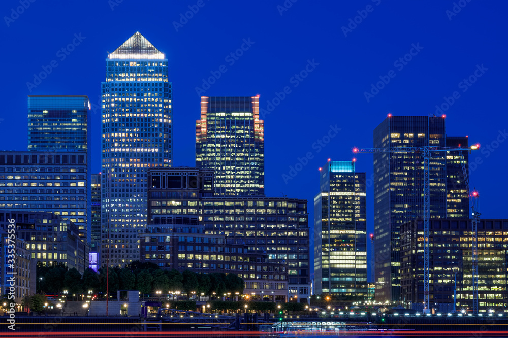 Illuminated Canary Wharf cityscape financial hub in London at night Illuminated Canary Wharf cityscape financial hub in London at night