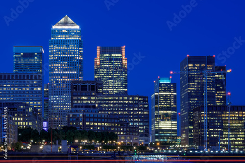 Illuminated Canary Wharf cityscape financial hub in London at night