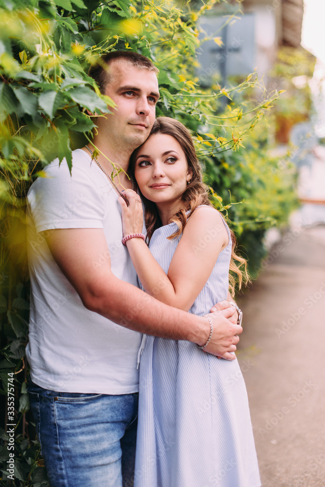 Loving couple on a city street. Portrait of a guy and a girl of love story. Life style Loving couple on a city street. Portrait of a guy and a girl of love story. Life style