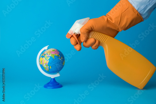 Hand holding hand sprayer and spraying earth globe map model  cleaning and disinfection concept.