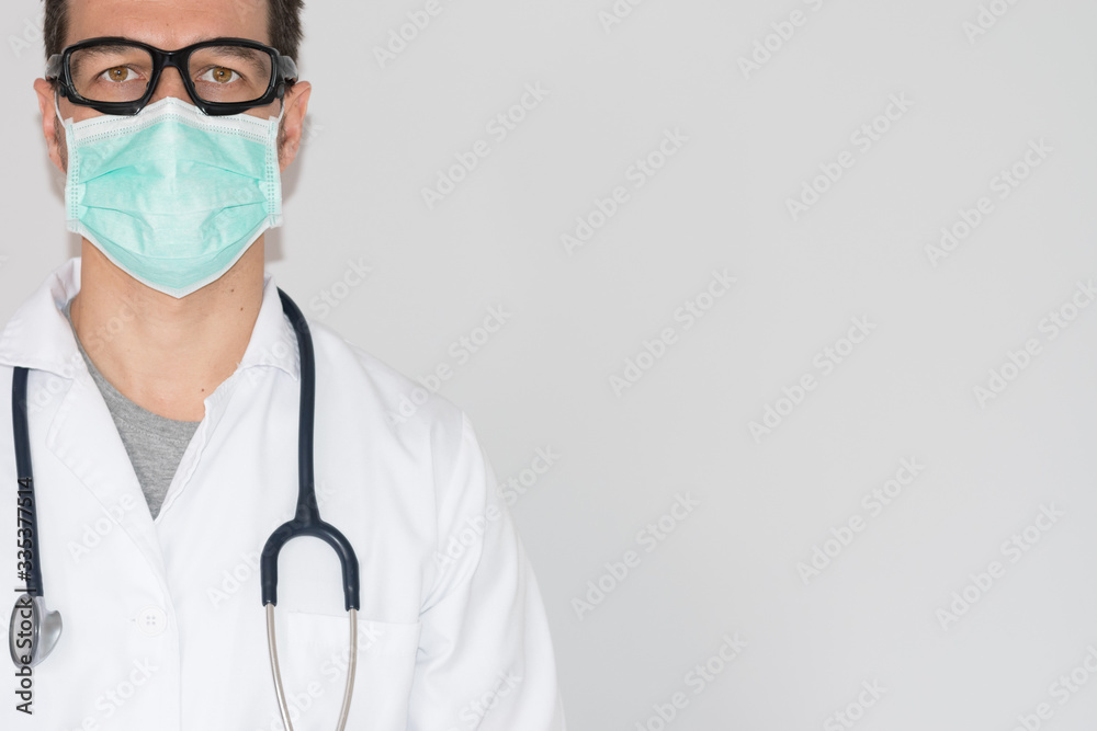The doctor with a mask and goggles on an insulated white background The doctor with a mask and goggles on an insulated white background