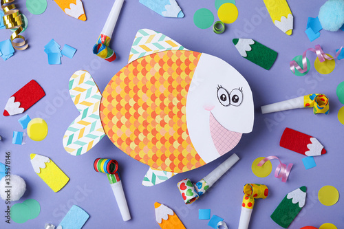 Wallpaper Mural Flat lay composition with paper fish and party decor on blue background. April fool's day Torontodigital.ca