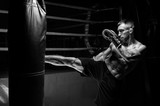 Kickboxer kicks the bag. Training a professional athlete. The concept of mma, wrestling, muay thai.