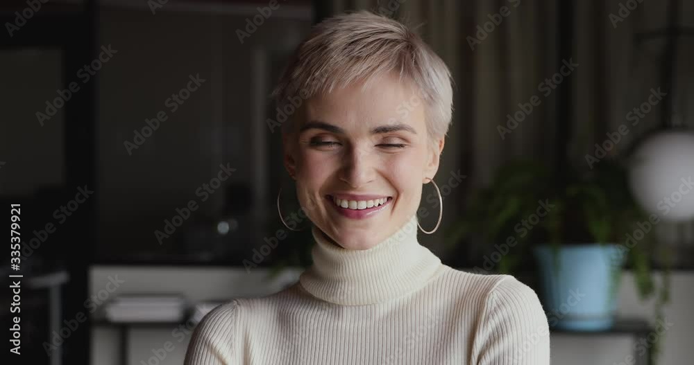Confident young short haired blond business woman looking at camera. Serious smiling millennial professional manager, successful entrepreneur, female worker posing for closeup portrait at home office. Confident young short haired blond business woman looking at camera. Serious smiling millennial professional manager, successful entrepreneur, female worker posing for closeup portrait at home office.