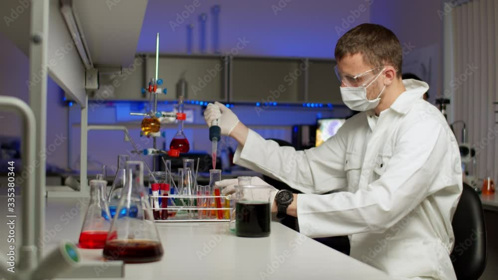 Young scientist mixing colored liquids Young scientist mixing colored liquids
