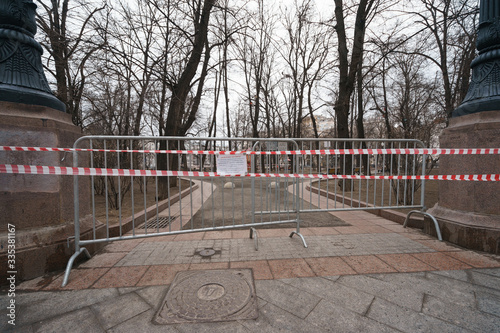 Desert Playground, closed boulevard. Tape fence. Traslation of the text - Dear Muscovites! In order to avoid coronavirus infection, please limit your stay in park area. Keep a social distance of 2 m.  photo