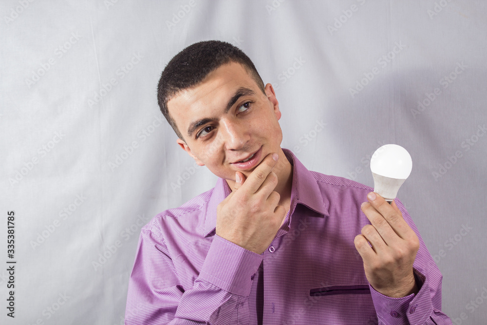 businessman holds a lit lamp and thinks businessman holds a lit lamp and thinks