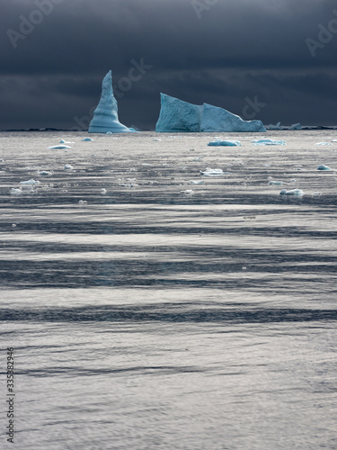 blue sharped iceberg and sea with little waves in Antarctica
