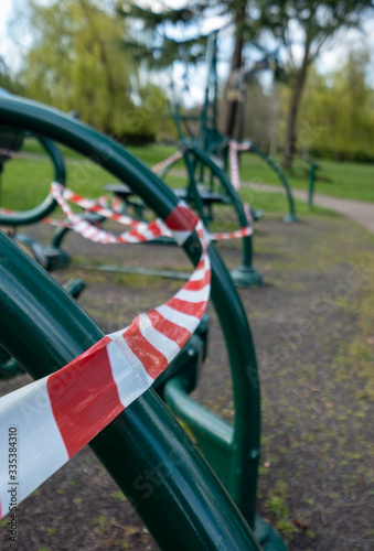 Outdoor exercise equipment in local park in Pinner, Middlesex UK is cordoned off during the Covid-19 coronavirus pandemic, March 2020. © Lois GoBe