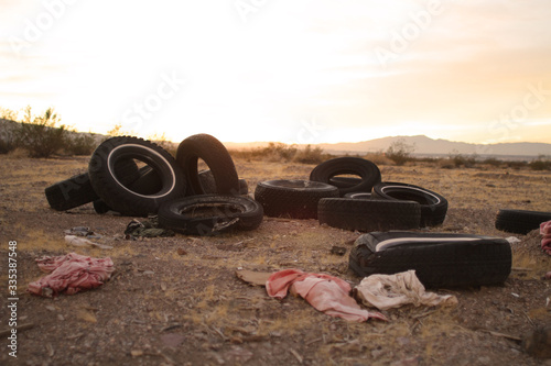 old worn out tires left to rot in a trash pile