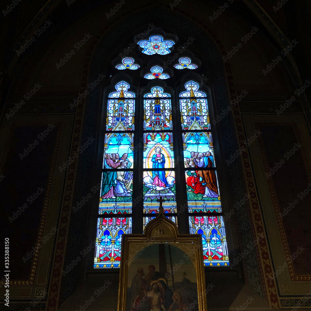 Stained glass window inside a dark church Stained glass window inside a dark church