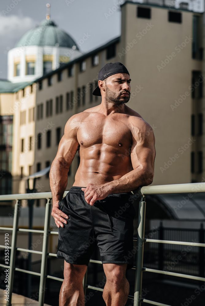 Obraz premium Sexy athlete sucks and poses topless. Europe.