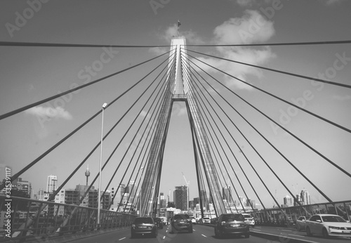 Black and white shot of Harbor Sydney bridge from low angle 