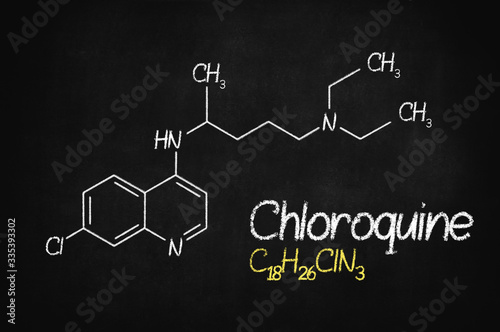 Chloroquini phosphas, chloroquine medicine substance. Drug introduced as treatment for coronavirus (SARS-CoV-2). Active in COVID-19 supportive therapy. Chemical formula written with chalk on board.