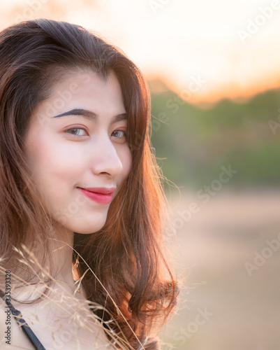 Beautiful young blonde asian woman with blur background, Close Up face and eyes woman facing camera
