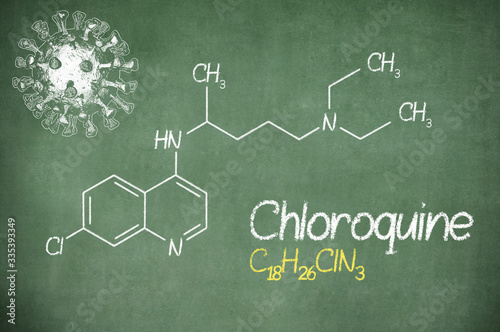 Chloroquini phosphas, chloroquine medicine substance. Drug introduced as treatment for coronavirus (SARS-CoV-2). Active in COVID-19 supportive therapy. Chemical formula written with chalk on board.