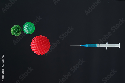 Syringe and virus covid 19 in dark background, 2019-nCoV virus in Wuhan, China. Global pandemic. Vaccine injection. Immunization and treatment from corona virus infection.