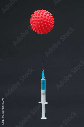 Syringe and virus covid 19 in dark background, 2019-nCoV virus in Wuhan, China. Global pandemic. Vaccine injection. Immunization and treatment from corona virus infection.