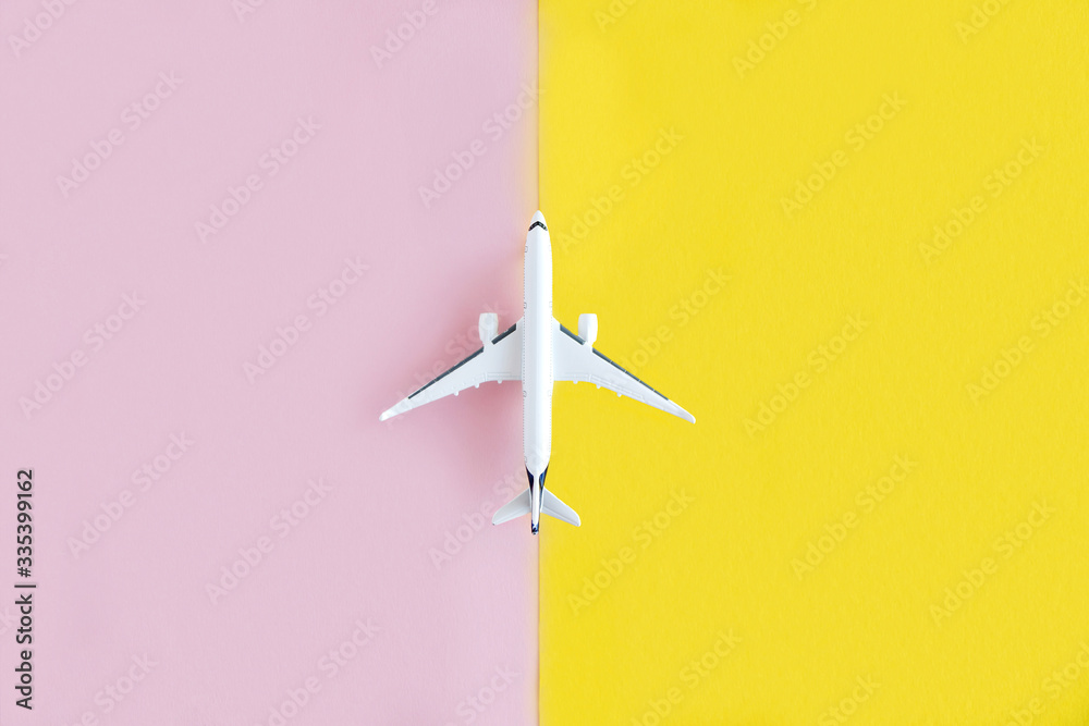 Model of a white plane on a yellow and pink background. Travel, flight concept. Place for text. Layout for design. Minimalism Model of a white plane on a yellow and pink background. Travel, flight concept. Place for text. Layout for design. Minimalism