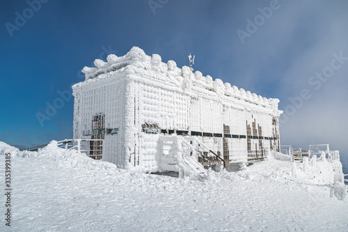Post office called Postovna on top of Snezka covered with frost. The peak of the Snezka Mountain in winter in the Krkonose Mountains. Czech Republic photo