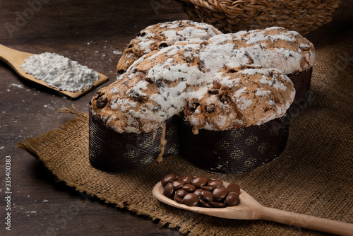 Easter dove bread (colomba Pasquale) made with filling of chocolate and wheat drops on a rustic wooden table. photo