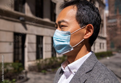 profile of Asian American New Yorker with face mask