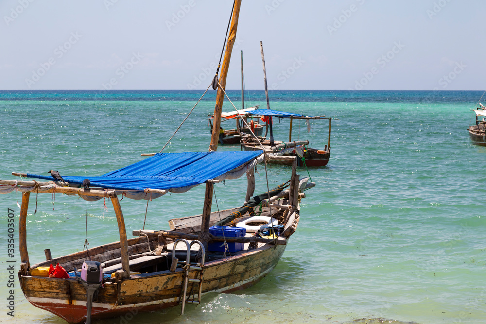 National traditional wooden african boats on the ocean surface National traditional wooden african boats on the ocean surface