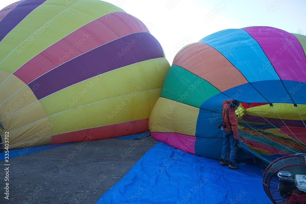 Fototapeta premium The atmosphere oat the balloon festival was fun and exciting to watch as the team members worked together to fill and launch the balloons.