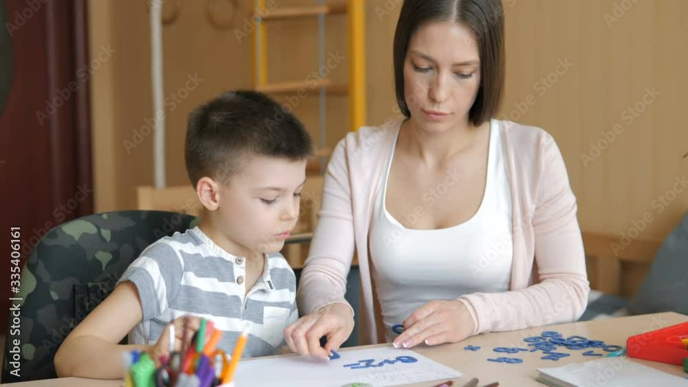 Home schooling. Mother and son doing art supplies homework Home schooling. Mother and son doing art supplies homework