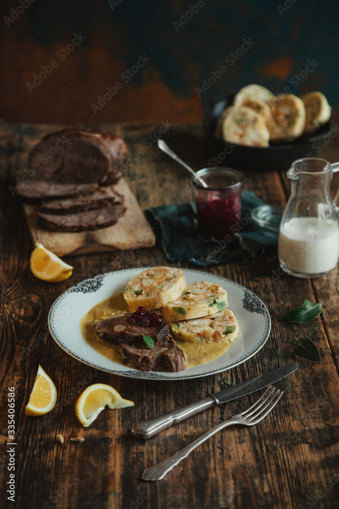 homemade meatloaf on a rustic table in a vintage plate, a carafe of milk and a jar of jam homemade meatloaf on a rustic table in a vintage plate, a carafe of milk and a jar of jam
