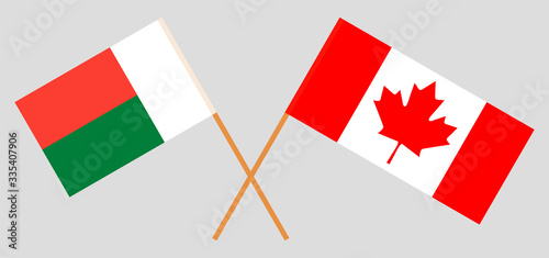 Crossed flags of Madagascar and Canada