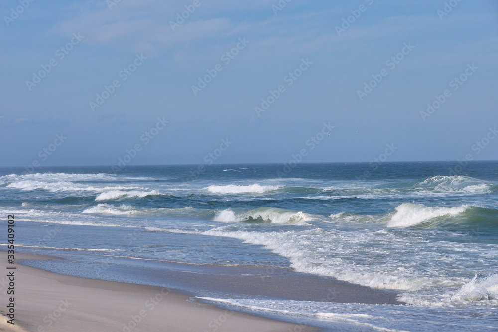 Heavy surf and whitecaps pound the fine sand beach at New Jersey's Island Beach State Park on a sunny but very windy day Heavy surf and whitecaps pound the fine sand beach at New Jersey's Island Beach State Park on a sunny but very windy day