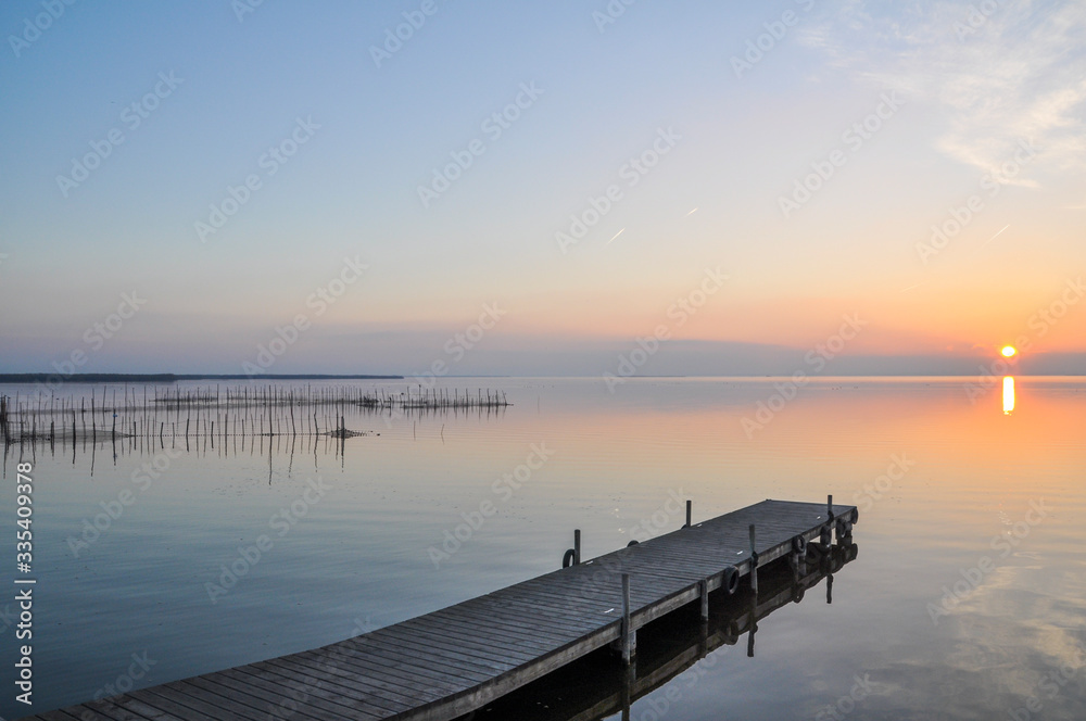 Sunset at pier in the Natural Park of the Albufera in Valencia